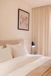 Una cama o camas en una habitación de Doryssa Theorem Hotel