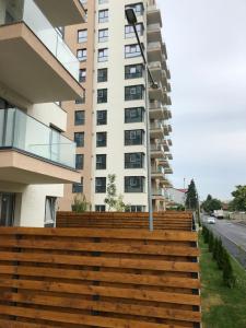 a building with wooden steps in front of a building at 4 Room Penthouse Terrace W18+W19 in Bucharest