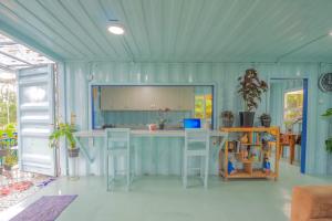 a blue kitchen with a island in a room at Rumah Container Bedugul in Bedugul