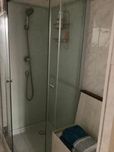 a shower with a glass door in a bathroom at No. 5 Plaisance - Room 2 in Plaisance