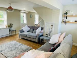 a living room with a couch and a table at Entire 2 bed cottage - Llangwm in Llangwm