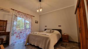 a bedroom with a bed and a window at Anna Garden Sidari in Sidari