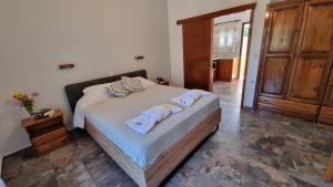 a bedroom with a bed with towels on it at Anna Garden Sidari in Sidari