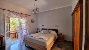 a bedroom with a bed and a window at Anna Garden Sidari in Sidari