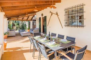 a dining room with a table and chairs at Can Canaves in Pollença