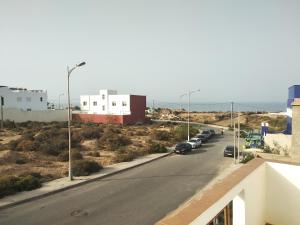 a street with cars parked on the side of a road at Villa Safia in Imsouane +19 photos