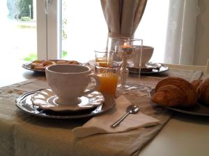 a table with a cup of coffee and bread at Dear Venice Bed & Breakfast in Marghera