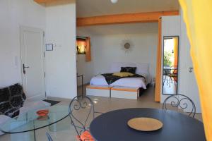 a bedroom with a bed and a glass table at Maison d'Hôtes Bleu Azur in Tourrettes-sur-Loup