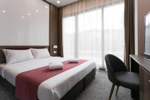 a hotel room with a bed and a television at B1 Boutique Hotel Sofia in Sofia