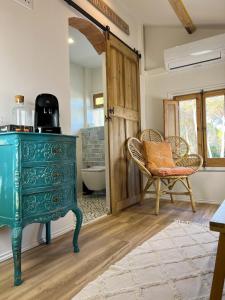 a green dresser in a bathroom with a tub at Can Jan Vives in Vidreres