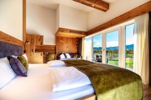 a bedroom with a large bed with a large window at Landhotel zum Wagen in Achern