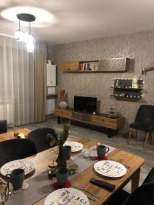 a living room with a table with plates on it at Luxury Apartments Studenets in Pamporovo