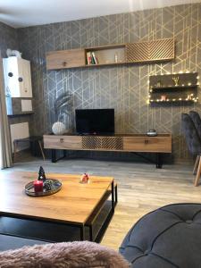 a living room with a coffee table and a tv at Luxury Apartments Studenets in Pamporovo