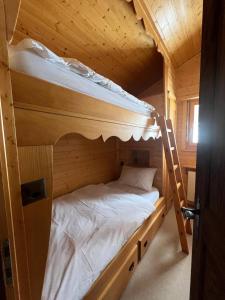 a bedroom with two bunk beds in a cabin at Superb Attic Apartment in Les Esserts in Verbier +2 photos