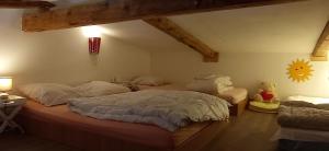 a bedroom with two beds and a teddy bear at Logis Saint Roch in Saint-François-Longchamp