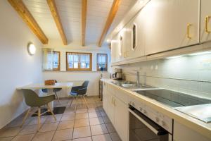 a kitchen with a sink and a table at Ferienwohnung G. Füglein in Oberstdorf