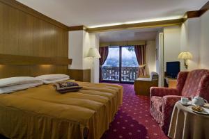 Postel nebo postele na pokoji v ubytování Hotel Catinaccio Rosengarten