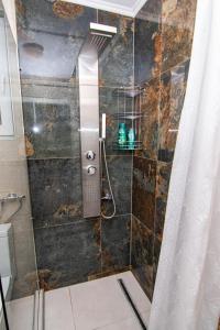 een douche met een glazen deur in de badkamer bij 5 min walk to Bascarsija! WOW! in Sarajevo