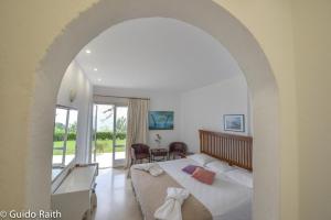 a bedroom with a bed with an archway at Ionian Sea View Studios by Hotelius in Episkopianá