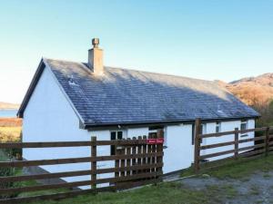 a white house with a fence in front of it at Borve House, Kilchoan in Kilchoan