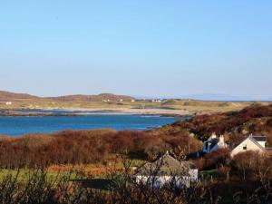 a view of a body of water with a house at Borve House, Kilchoan in Kilchoan