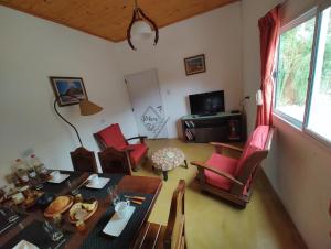 a living room with a dining table and chairs at Rikra Purmamarca in Purmamarca