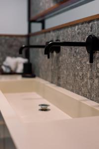 a bathroom sink with a black faucet at Villa Vrachos luxury Living in Vrachos