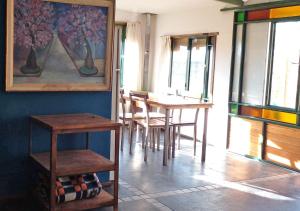 a dining room with a table and chairs and windows at El Atelier - Valle de Uco in La Consulta