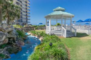 a gazebo next to a river in a park at Edgewater Beach Resort by Panhandle Getaways in Panama City Beach