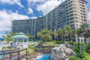 a large building with a gazebo in front of a resort at Edgewater Beach Resort by Panhandle Getaways in Panama City Beach