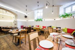 a restaurant with tables and chairs in a room at Miss Sophie's New Town & Wellness in Prague