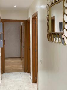 a hallway with a mirror and a room with a door at Superbe Appartement au coeur de Casablanca in Casablanca