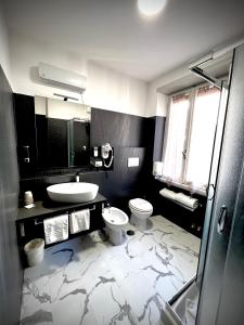 a bathroom with a toilet and a sink at Prati Comfort in Rome