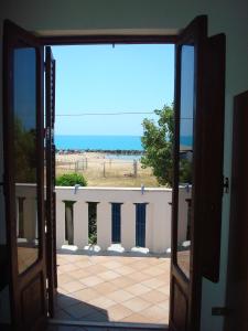 eine offene Tür zu einem Balkon mit Meerblick in der Unterkunft B&B Nettuno San Leone in San Leone