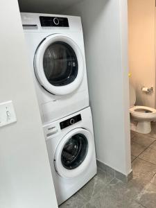 a washing machine and a washer and dryer in a bathroom at Apt Downtown Detroit with VIEW in Detroit