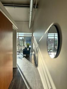 a hallway with a mirror and a chair in a room at Apt Downtown Detroit with VIEW in Detroit