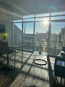 a room with a glass table and a large window at Apt Downtown Detroit with VIEW in Detroit