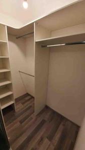 an empty room with a closet with wooden floors at New apt in new building located begin of Petrzalka in Bratislava