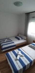 two beds sitting next to each other in a room at VILA RENATA in Grižane