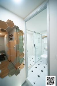 La salle de bains est pourvue d'une douche en verre et de toilettes. dans l'établissement 虎尾小9窩, à Huwei