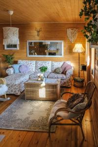 a living room with a couch and a table at Alemiło - uroczy dom z balią i widokiem na Babią Górę in Zawoja