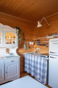 a kitchen with white appliances and a wooden ceiling at Alemiło - uroczy dom z balią i widokiem na Babią Górę in Zawoja +83 photos