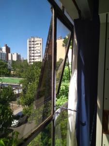 a window with a view of a city at Luminoso monoambiente con cochera propia dentro del edificio in La Plata
