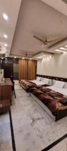 a room with a row of beds in it at Hotel Orange Classic in Rishīkesh