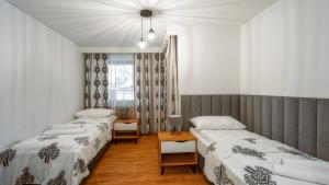Posteľ alebo postele v izbe v ubytovaní Apartamenty Sun & Snow Resorts F Białka Tatrzańska z sauną