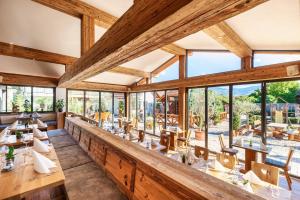 a dining room with tables and chairs and large windows at Landhotel zum Wagen in Achern