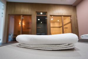 a stack of towels sitting on top of a table at B1 Boutique Hotel Sofia in Sofia