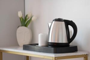 - une bouilloire de thé noir et blanc sur une table avec un vase dans l'établissement Villa B, à Salernes