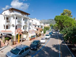 a street with cars parked on the side of a building at Guest House Dolce Vita in Cala Gonone