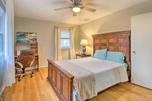a bedroom with a bed and a chair and a ceiling fan at Cozy Woodbridge Home with Fire Pit and Deck in Woodbridge